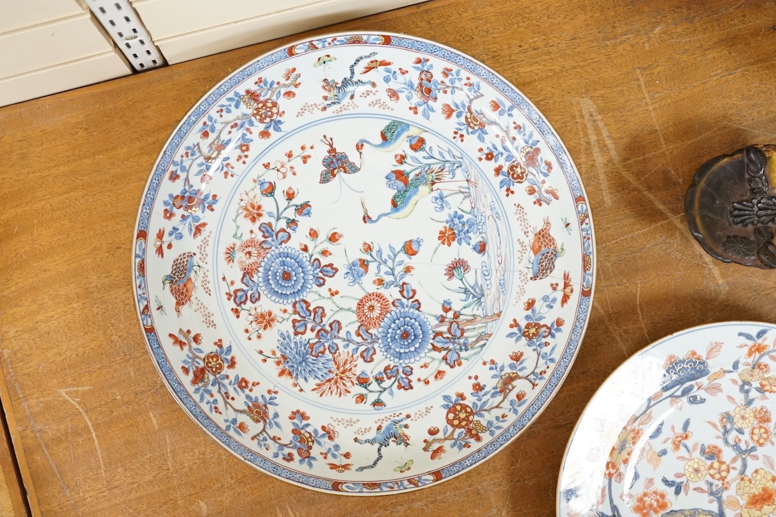 Three early 18th century Chinese Imari dishes (one clobbered), largest 46.5cm, together with a 19th century Chinese powder blue ground vase, 44cm high and a horn carving, 13.7cm (5)